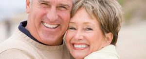 Senior couple share a hug and smile 