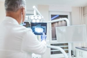 Dentist analyzing X-rays 
