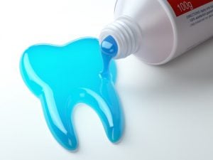Toothpaste spills into the shape of a tooth