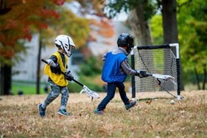 Two kids playing lacrosse 