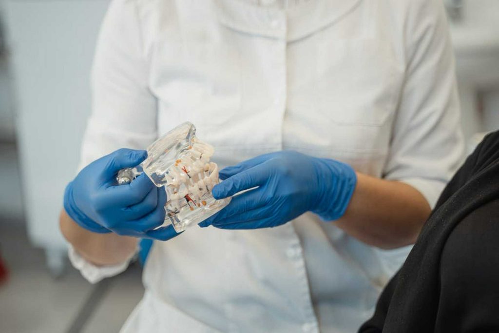 Dentist holding dentures
