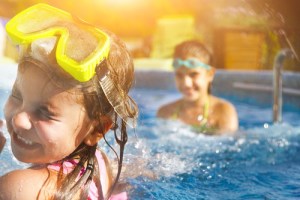 Two kids playing in pool