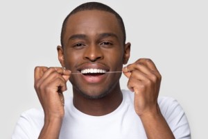 Man flossing his teeth