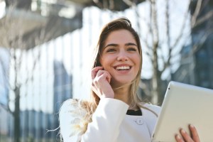 woman in a white blazer smiling