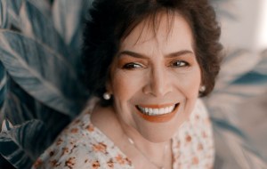 A smiling senior woman in a floral shirt