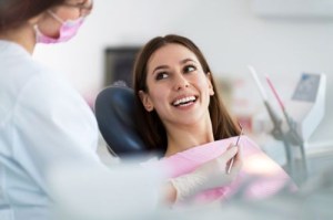 Woman Smiles While Dentist Talks To Her